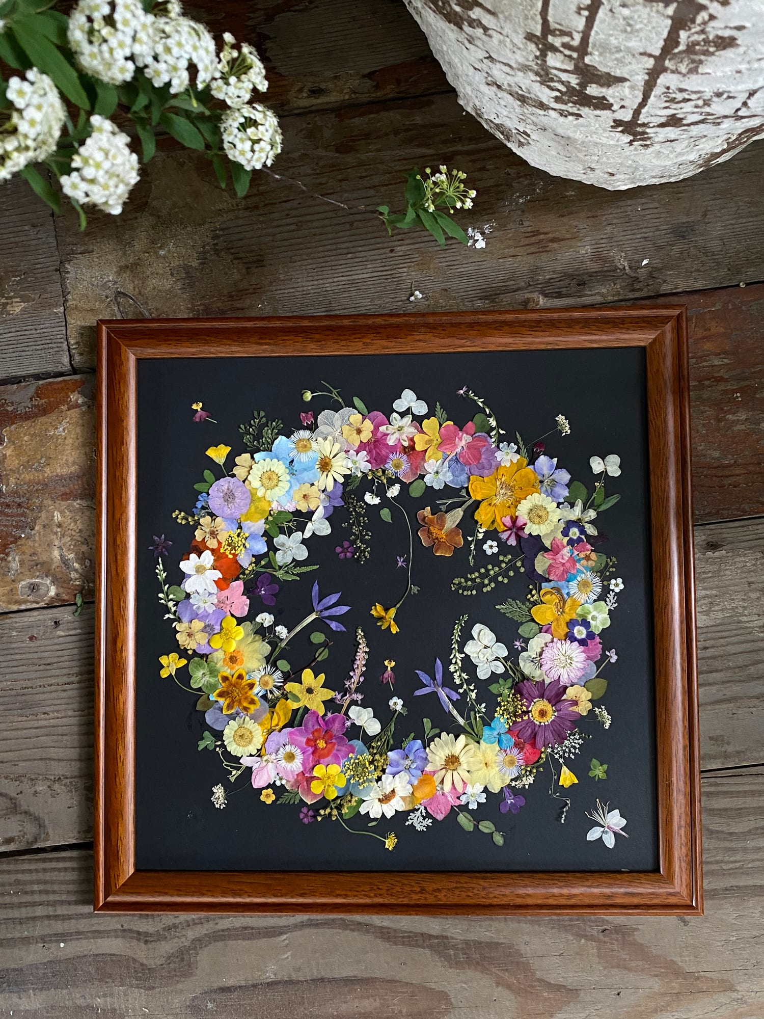 Framed pressed-flower botanical artwork from the studio